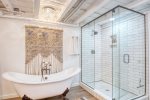 Full bathroom with a luxurious soaking tub and separate shower